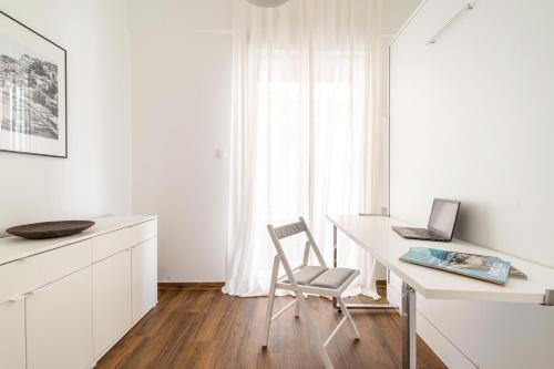 a white desk with a laptop and a chair at Superb flat in the historic centre of Athens in Athens