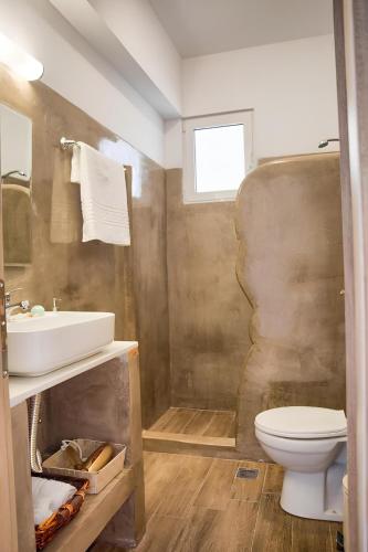 a bathroom with a sink and a toilet at La mer stegna in Archangelos