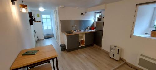 a small kitchen with a table and a counter top at Studio Laval in Laval