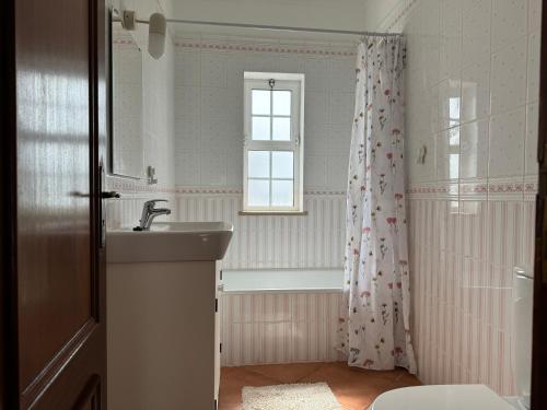 a bathroom with a sink and a bath tub at Villa Mar in Albufeira