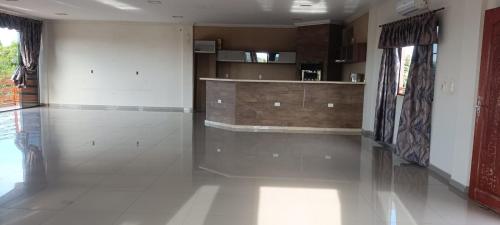 a large living room with a white tile floor at Ñande renda in Ciudad del Este