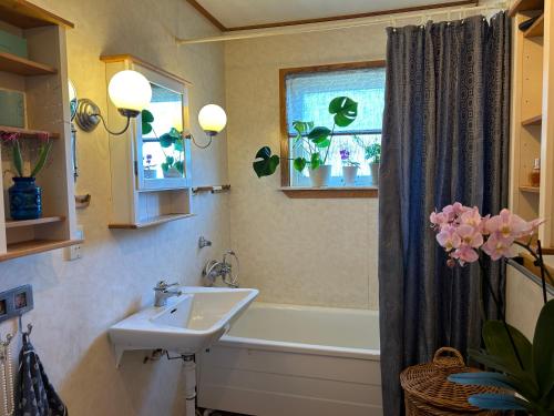a bathroom with a sink and a bath tub at Lysekil sunset Villa in Lysekil