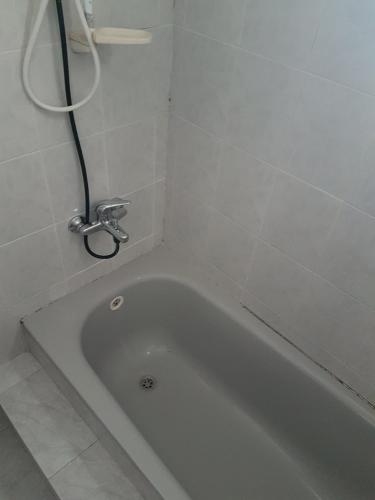 a white bath tub in a bathroom with a shower at Gilad in Qiryat Yam