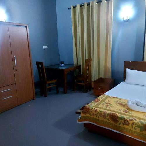 a bedroom with a bed and a table and a table at Orina Hotel in Colombo