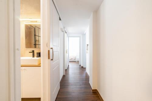 a hallway with white walls and wooden floors at Superb flat in the historic centre of Athens in Athens