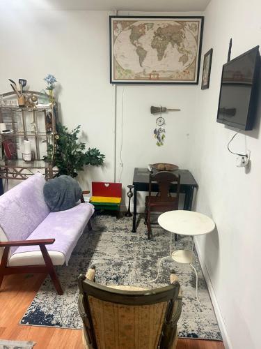 a living room with a couch and a table at Charming Studio Flat Near Center City in Philadelphia