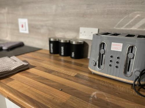 a toaster sitting on top of a wooden counter at Cosy Studio 6 with Free Parking in Birmingham