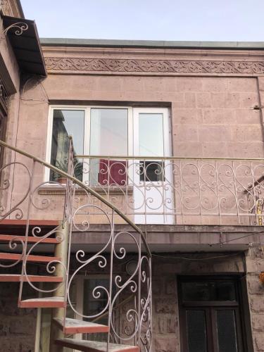 a balcony with a wrought iron railing and a window at Sweet house in Gyumri