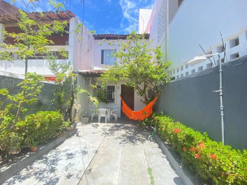 a patio with an orange hammock in a building at Quarto em stella maris in Salvador