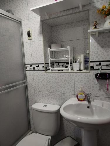 a small bathroom with a toilet and a sink at EL MANZANO in Lima