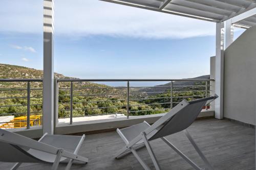 two chairs on a balcony with a view at Mountain Villa Panorama in Stavrokhórion