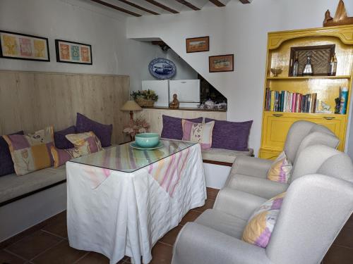 a living room with a table and two couches at Alojamiento Rural El ROMERO in Sabiote