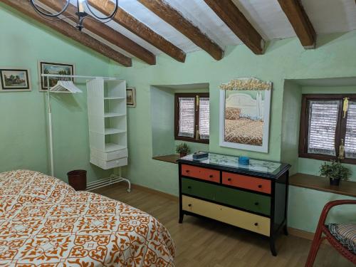 a bedroom with a bed and a dresser and a mirror at Alojamiento Rural El ROMERO in Sabiote