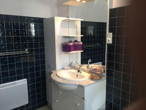 a bathroom with a sink and a mirror at Maison au calme vue sur les montagnes in Asté