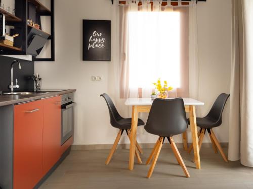 a kitchen with a table and chairs and a window at Golubina 1 - Studio Apartman in Golubac