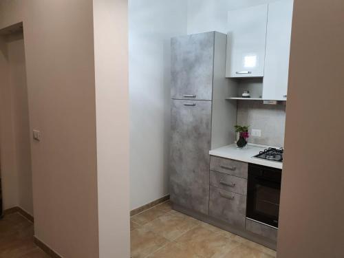 a kitchen with a stainless steel refrigerator and a stove at Villa Tellina Mare Luna in Granelli