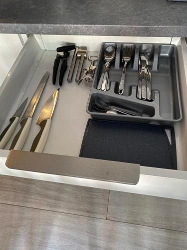 a drawer filled with utensils in a kitchen at Apartament Centrum Więckowskiego in Łódź