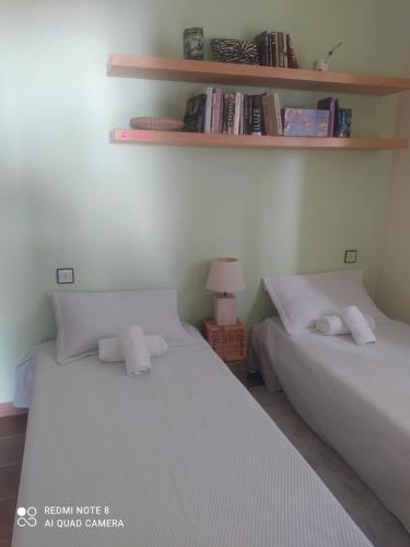 two twin beds in a room with shelves at Bramer 6 Canyelles in Roses