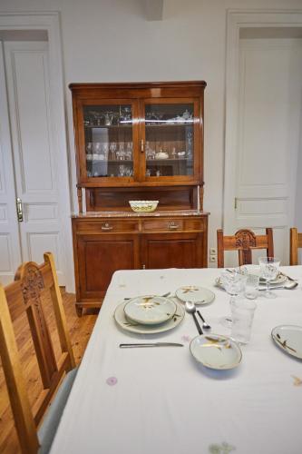 a dining room with a table with plates on it at 1906 Citygarden in Chios