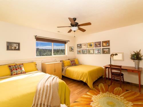 a bedroom with two beds and a ceiling fan at Red Hollow Ranch- Pet Friendly, Walking distance to Slot Canyon, Private in Orderville
