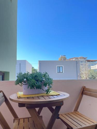 a table and two chairs on a balcony at Villa Beni Osmenaj in Vlorë