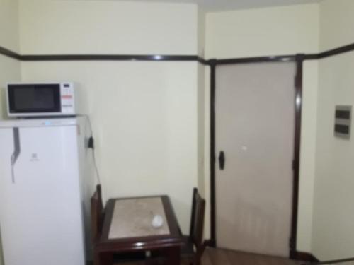 a room with two sliding doors and a microwave at Champs elysees in Sao Paulo