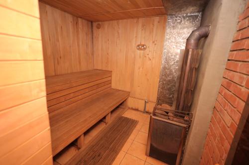 a sauna with a wood paneled wall and a pipe at Приватна садиба Дикий Мед in Ploskoye