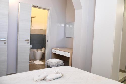 a white bathroom with a sink and a toilet at Casa Franca in Maracalagonis