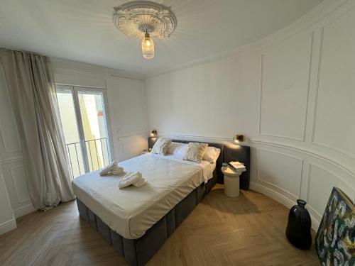 a bedroom with a bed with towels on it at Luxury Cathedral Views in Seville in Seville