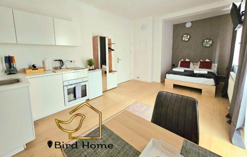 a living room with a kitchen and a dining room at Bird Home Room 11 in Klagenfurt