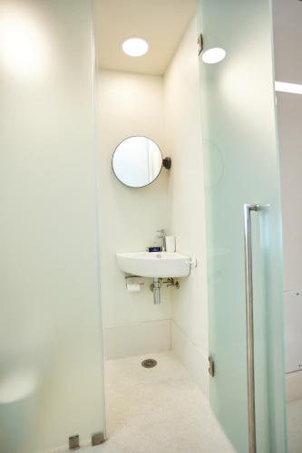 a bathroom with a sink and a mirror at 1906 Citygarden in Chios