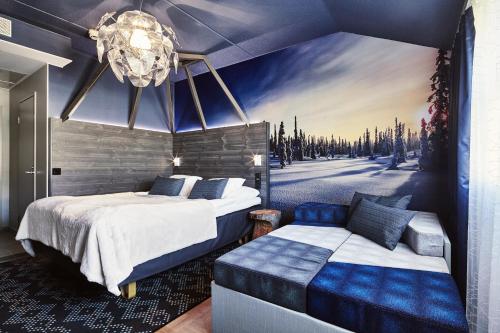 a bedroom with two beds and a painting on the wall at Original Sokos Hotel Vaakuna Rovaniemi in Rovaniemi