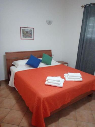 a bedroom with a bed with towels on it at Casa di Cristina in Fiumicino