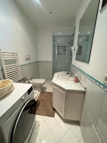 a bathroom with a sink and a toilet and a mirror at Casa Wizzy in Vico Equense