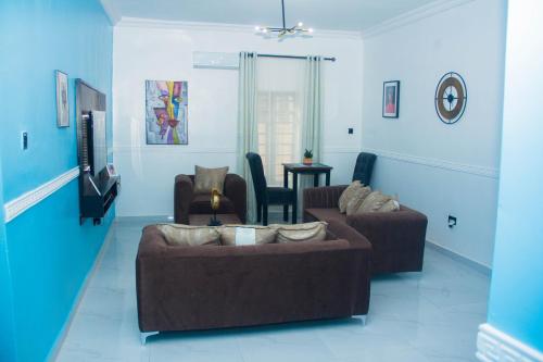 a living room with two couches and a tv at 3Tee Serviced Apartment Abeokuta in Abeokuta