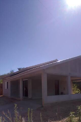 a house with a solar roof on top of it at Casa Bela Vista in Gravatal