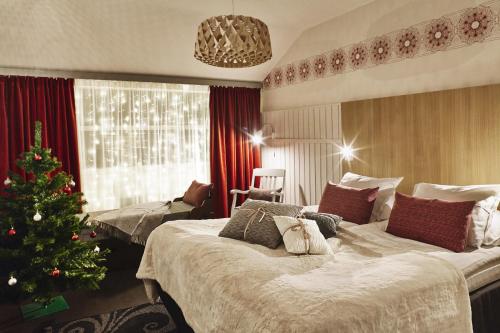 a bedroom with a christmas tree and a bed at Original Sokos Hotel Vaakuna Rovaniemi in Rovaniemi