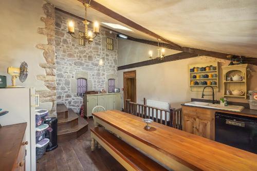 a kitchen with a wooden bench in a room at Medieval Manor in Caldicot