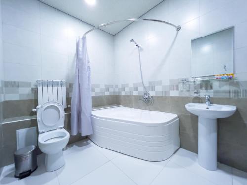 uma casa de banho com uma banheira, um WC e um lavatório. em Marakanda Hotel Samarkand em Samarkand