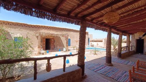 a porch of a house with a swimming pool at kasbah luna del sur in Erfoud