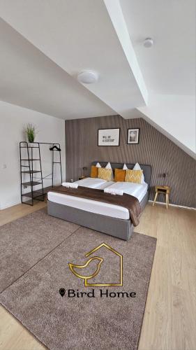 a bedroom with a large bed in a room at Bird Home Room 15 in Klagenfurt