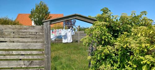 a wooden fence with a clothesline and a clothes line at Stort semesterhus med sol in Båstad