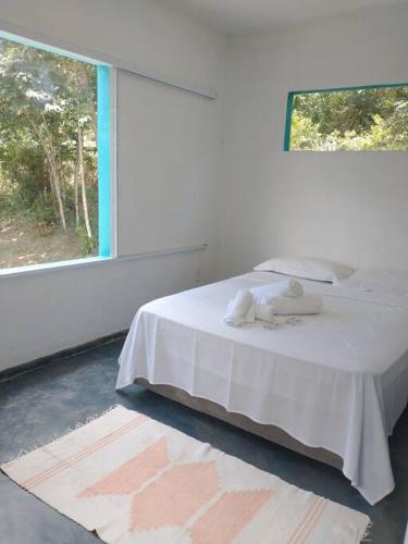 מיטה או מיטות בחדר ב-Casa do Bosque