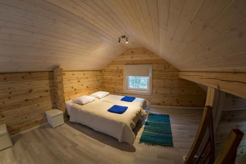 a bedroom with a bed in a log cabin at Hapsal Forest Cabin in Haapsalu