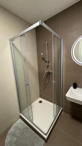 a shower with a glass enclosure in a bathroom at AR ALBELLI HOUSE II in Košice