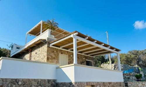 a house with a large white board in front of it at Cottage Vittoria - Marina di Novaglie in Gagliano del Capo