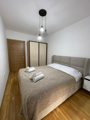 a bedroom with a bed with two towels on it at Diamond Apartment in Strumica