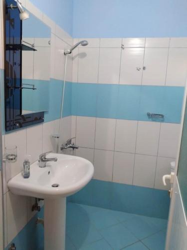 a bathroom with a sink and a mirror at Vila DINI Ksamil in Ksamil