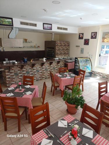a restaurant with tables and chairs in a room at Palm Inn Hotel Hurghda in Hurghada