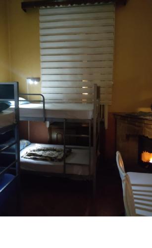 a room with two bunk beds and a chair at SW HOSTEL by EMIL in Baku